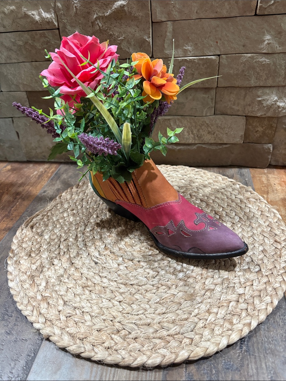 Women's colorful western Boot with faux flowers on circular mat.